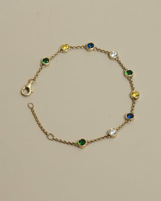 Gold Alba bracelet on a beige background