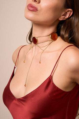 Model wearing the ZOGO Roya Gold choker, a statement necklace with three agate gemstones and cascading gold chains.